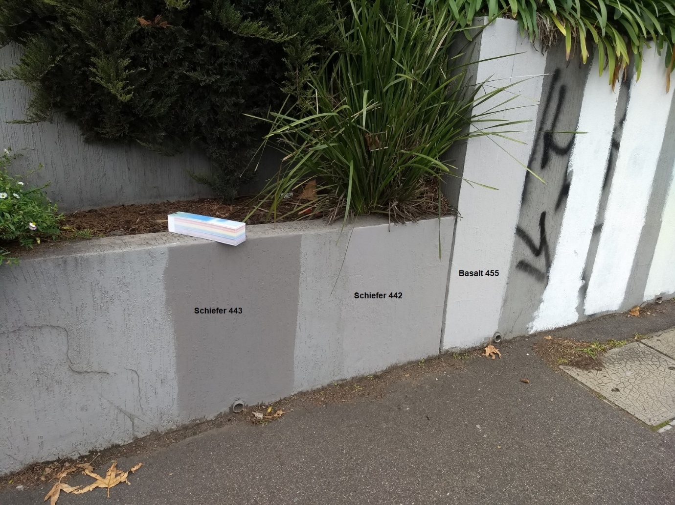 Several grey coating colours tested on the exterior wall
