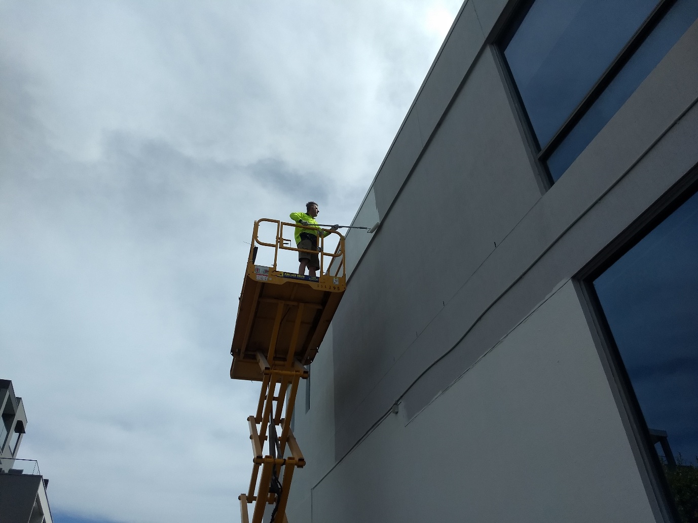 OmniGuard Exterior being applied from a scissor lift